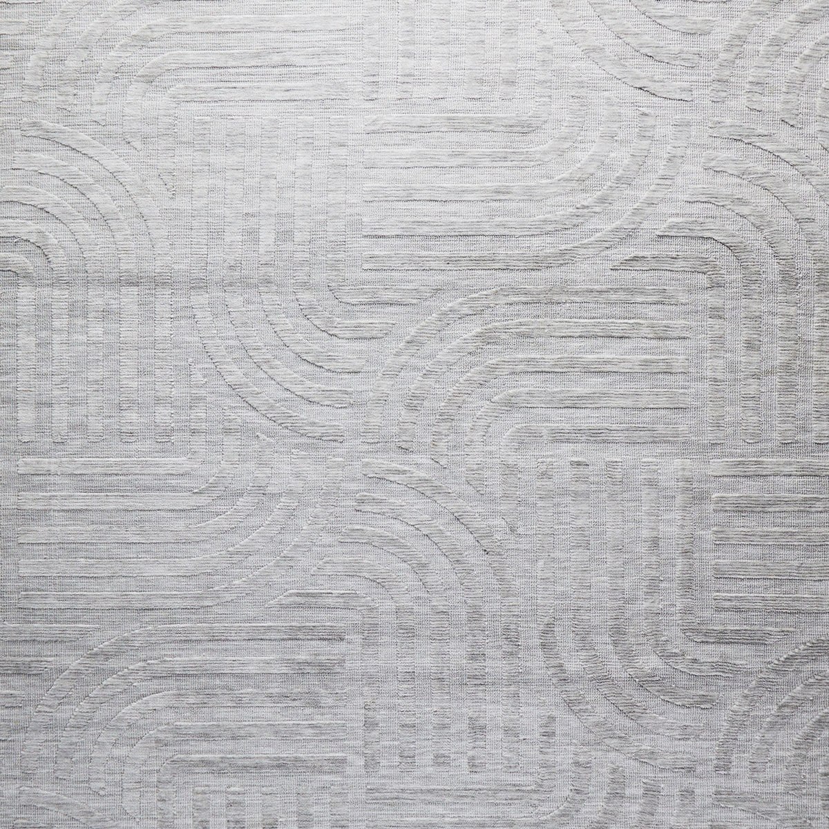 The Tufted Teal Jules Rug 300x240cm features a subtle geometric pattern of curved and straight lines, arranged symmetrically in a Mid-Century inspired design. The textured surface adds visual interest to any space.