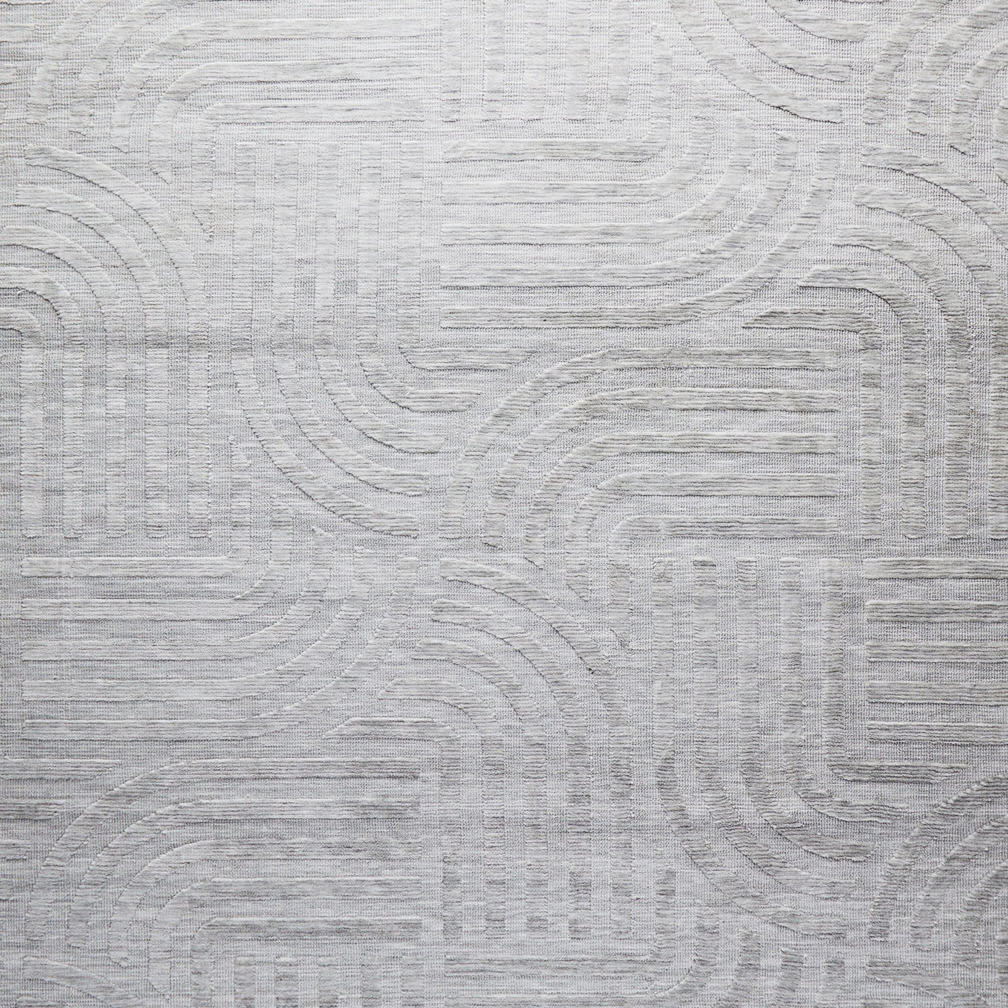 The Tufted Teal Jules Rug 300x240cm features a subtle geometric pattern of curved and straight lines, arranged symmetrically in a Mid-Century inspired design. The textured surface adds visual interest to any space.