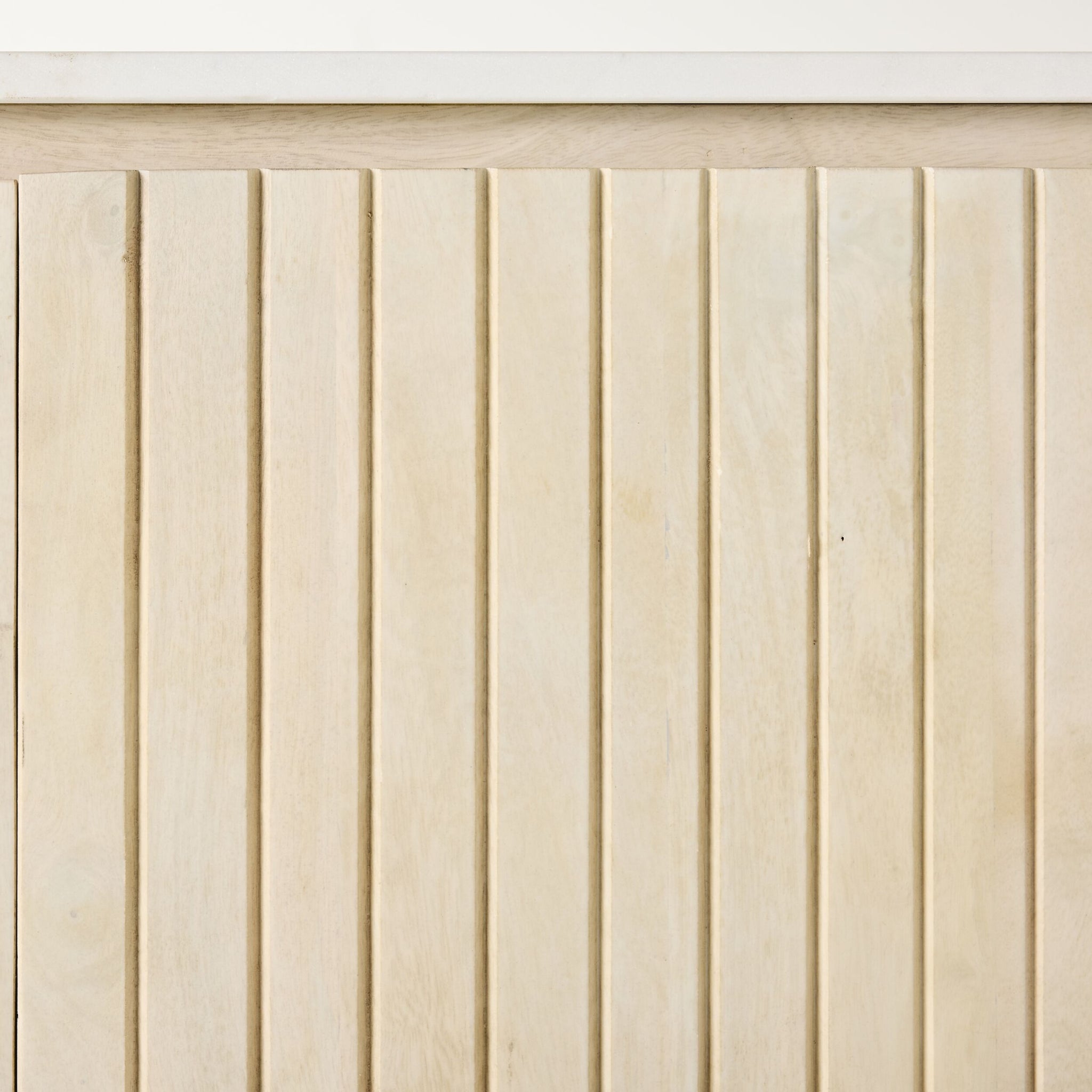 Vertical white-washed mango wood slats with slim gaps sit beneath a smooth marble top, enhancing the elegance of the Deva 4 Door Buffet 170 x 80 x 43cm.