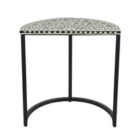 The Bone Inlay Half Moon Side Table Black with Black Frame 44cm is a half-moon shaped black metal side table with a black and white design, featuring intricate geometric patterns that evoke the artistic elegance of bone inlay.