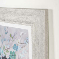 Close-up of the Arthouse Sea Isle Wildflowers Framed Print 57x57cm, showcasing a floral design with pastel colors on a white background within a light wood frame, providing a calming accent to any room.