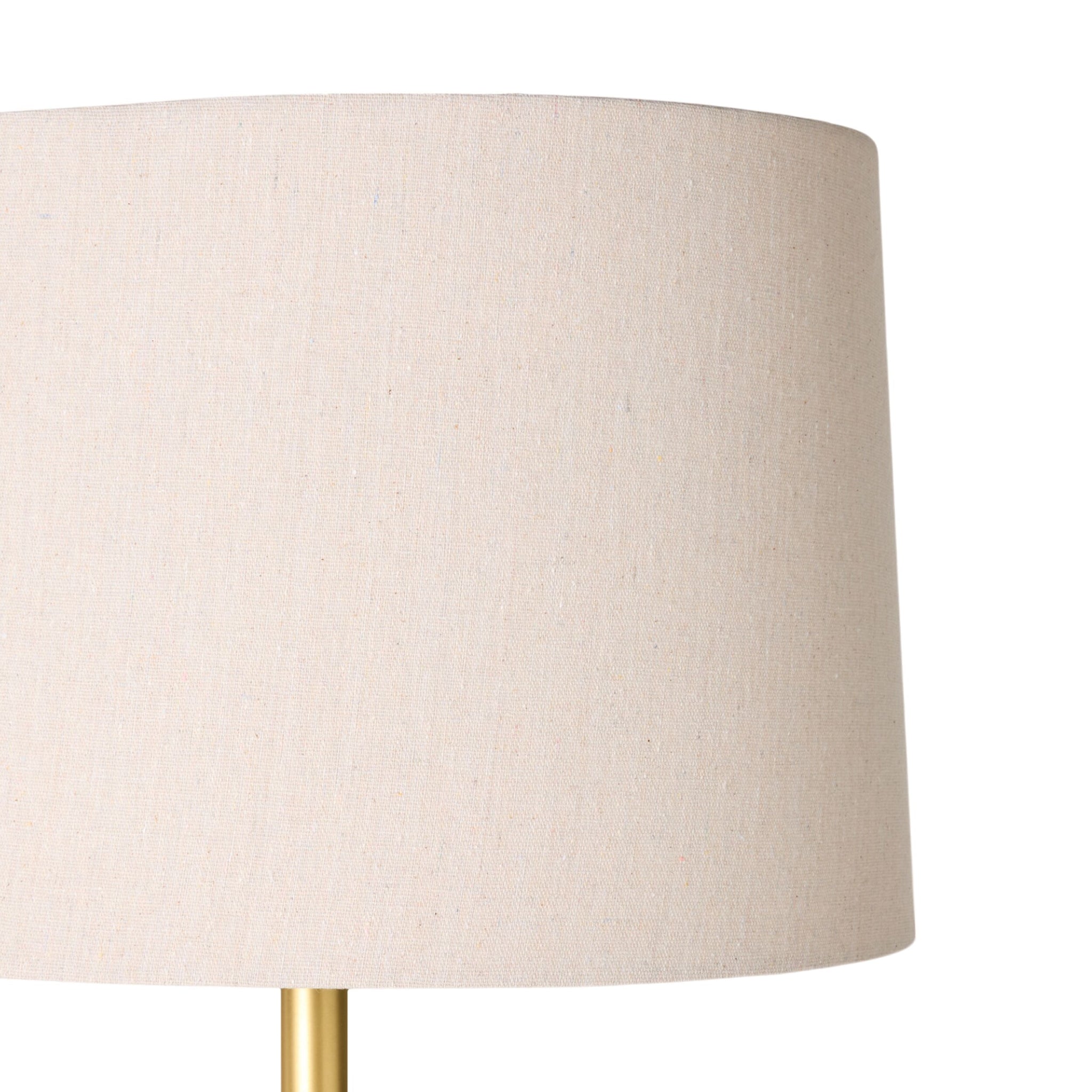 Close-up of the Siena Round Travertine Floor Lamp 155cm, featuring a beige fabric shade and gold metal base, photographed against a plain white background.