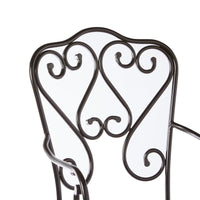 Close-up of the upper backrest of the Manette Outdoor Dining Chair Black M2, showcasing decorative scrollwork and a durable powder-coated black metal finish.
