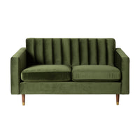The Stitch 2 Seater Velvet Sofa in Juniper Olive features a vertical tufted backrest, square arms, two seat cushions, and brass-capped legs for a sophisticated mid-century look, shown here against a white background.