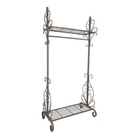 The Arlette Coat Rack Rail is an elegant unit with two open iron shelves and ornate scrollwork on the sides, finished in antique silver.