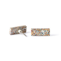 Two rectangular stud earrings with a vibrant Speckle Terazzo Knob Large 6.7cm pattern—one lies flat, the other reveals the metal post, echoing Early Settler’s distinctive decorative style.