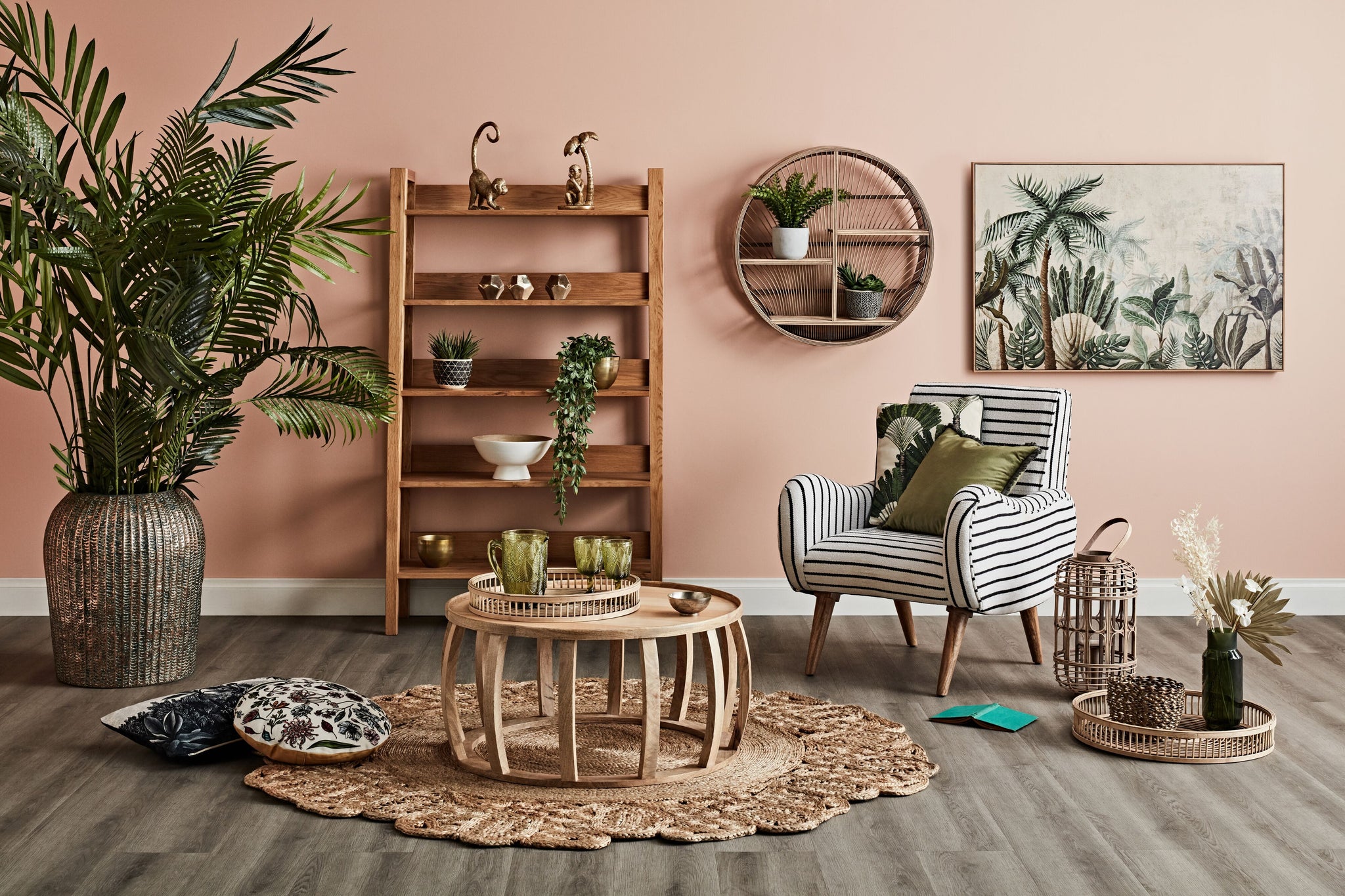 A living room with a black and white striped chair, a round coffee table, and a large plant