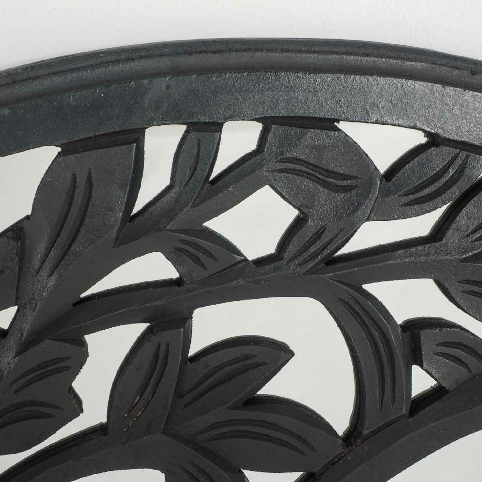 Close-up of the Frieze Tree Of Life Wall Hanging, 90x90cm, showcasing a black metal surface with a leaf pattern.