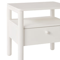 The Spintara 1 Drawer Bedside Table White features a single drawer with a round knob, rounded legs, and an open shelf—ideal for bringing coastal country style charm to your bedroom.