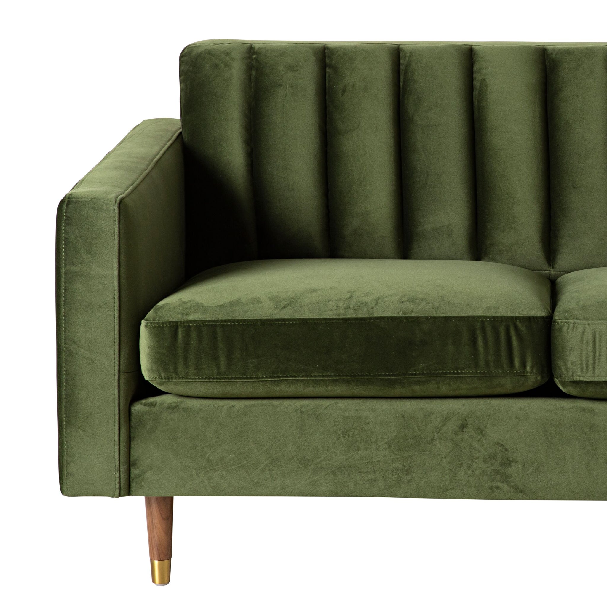 Stitch 2 Seater Velvet Sofa Juniper Olive shown from a front-side angle on a white background, featuring green velvet upholstery, vertical tufted backrest, wooden legs with brass caps, and gold metal foot detail.
