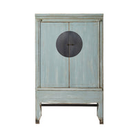 The Sansha Wedding Cabinet in Dove Grey is a beautiful vintage piece made from recycled pine wood, featuring two doors, a central circular metal handle, and exuding a touch of Chinese antique style.