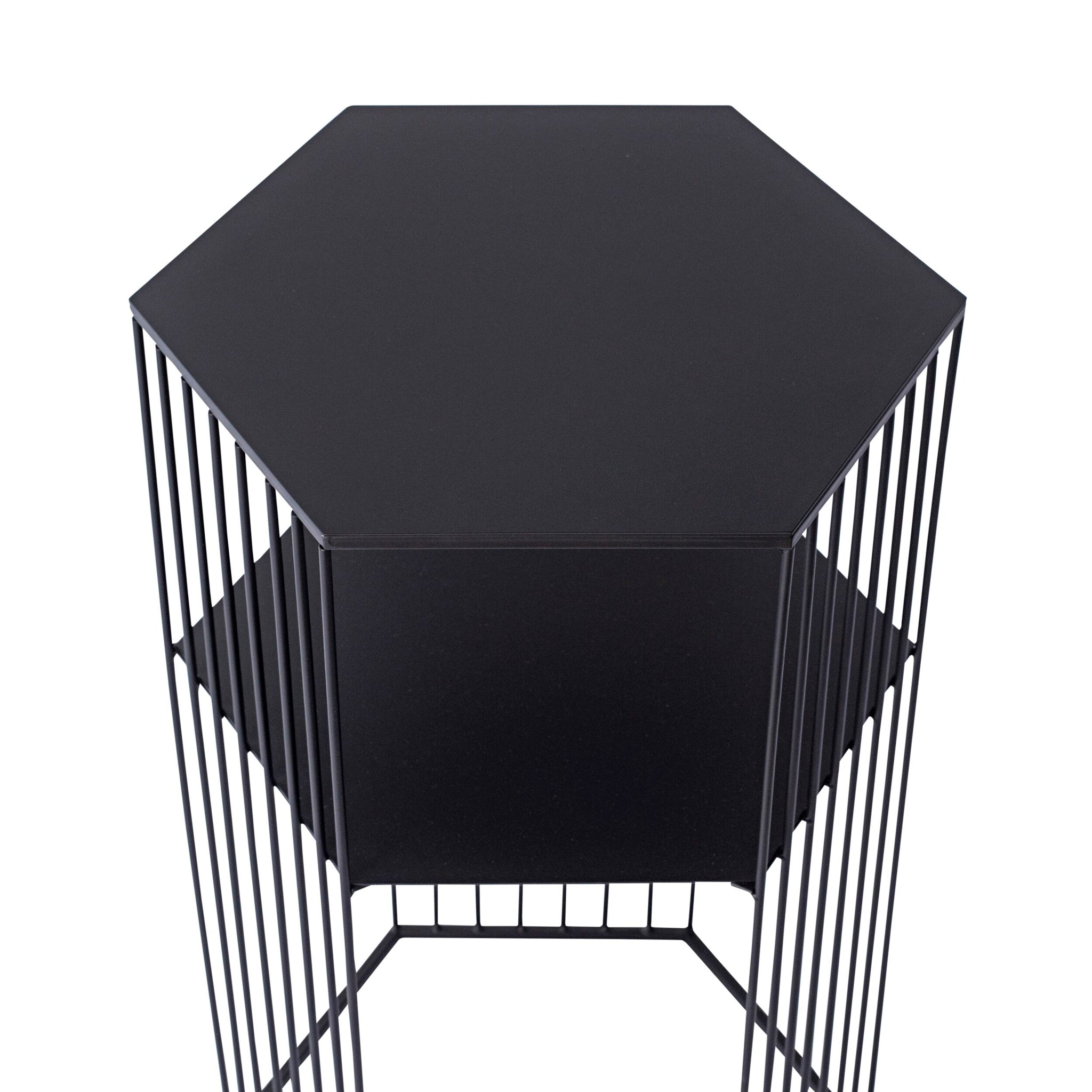 The Hendrix Bedside Table is a contemporary piece made from black powder-coated iron, featuring a minimalist hexagonal shape with thin vertical slats.