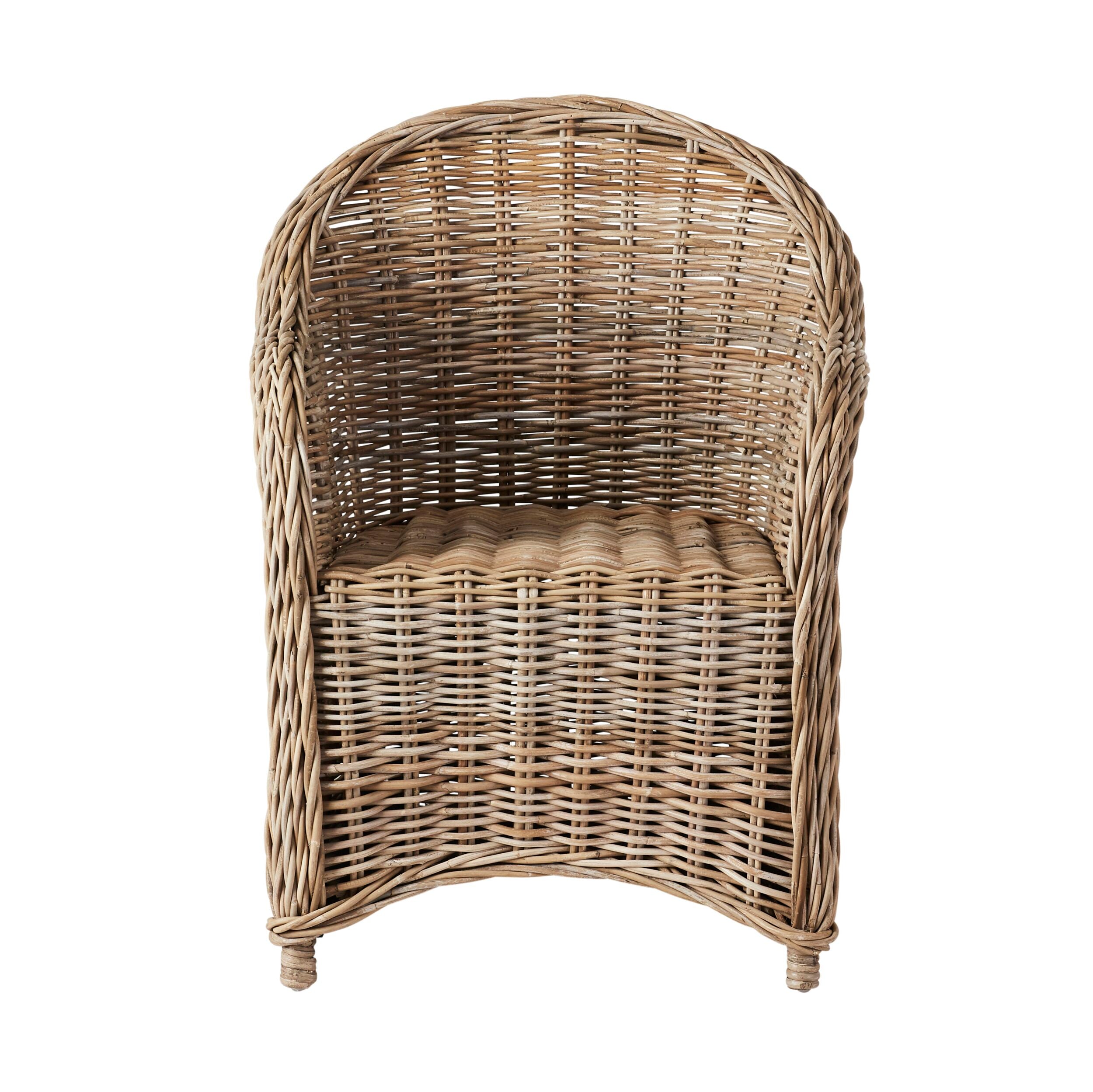 The Martinique Rattan Armchair features a rounded back and woven seat, capturing the tropical beauty of a Caribbean island with its natural rattan style.