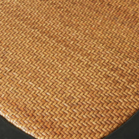 A close-up of the woven rattan texture in a basket pattern with a black border, similar to the intricate design seen on a Provincial Cross Back Dining Chair Black, reminiscent of classic Paris cafe style.