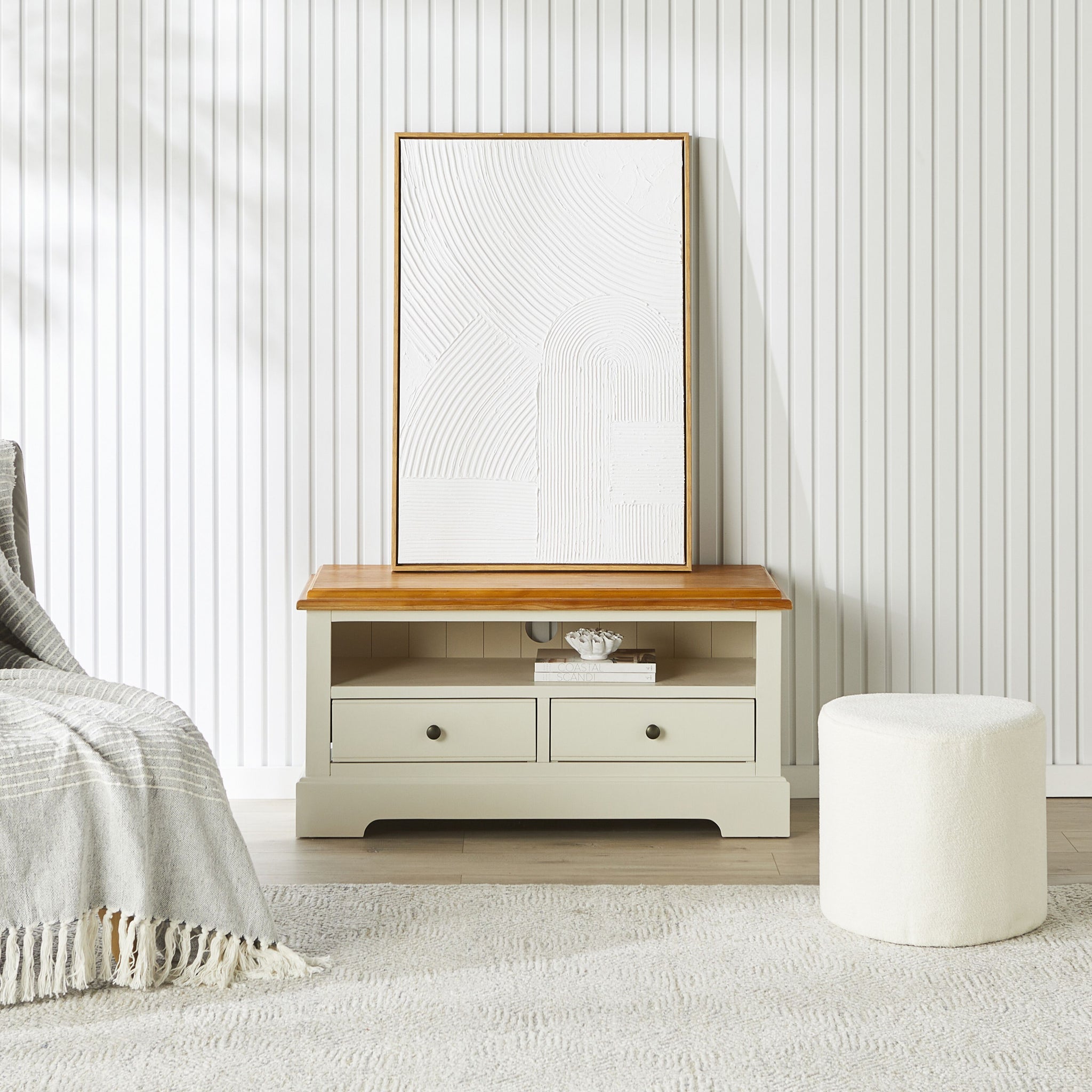 Close-up of wood top and creamy base detailing of the console, highlighting the leg and edge molding.