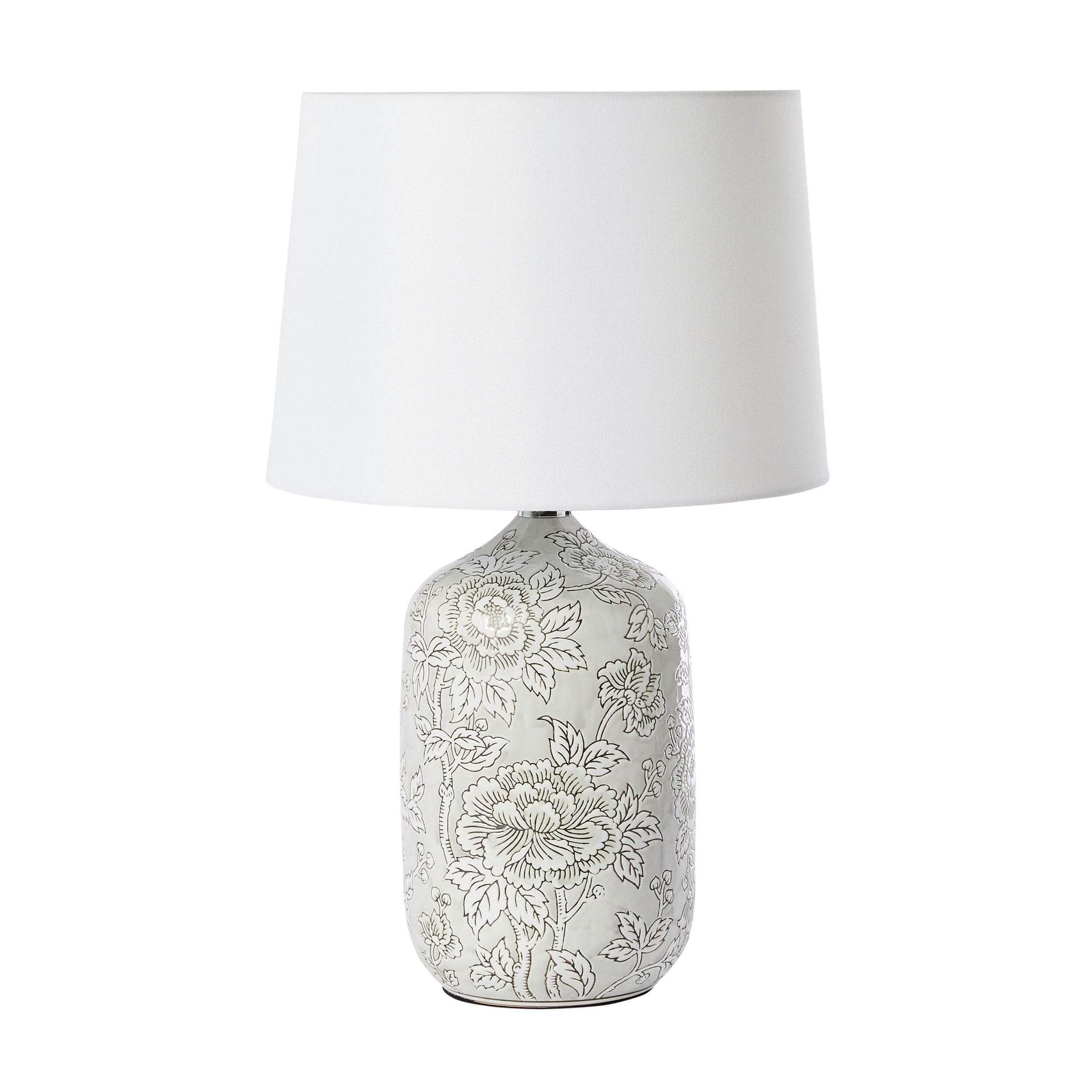 The Natural Hues Floral Table Lamp 61cm features a porcelain base with an elegant floral design in soft gray and comes with a white shade.