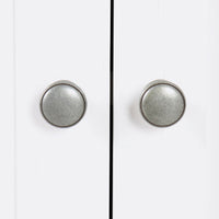 Close-up of two metal knobs on the white cabinet doors of a Clover Large Sideboard, inspired by Hamptons coastal design.