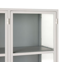 A close-up of the empty Nero 6 Door Display Cabinet (135 x 40 x 160cm) in white & grey, featuring glass doors, two shelves, and a sleek powder-coated finish for modern storage.