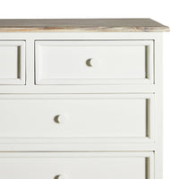 A close-up of the Maldon 9 Drawer Chest in Hamptons style, featuring white wood, nine drawers with round knobs, and a slightly weathered acacia timber top.