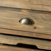Close-up of the Carter 2 Drawer Island Bench’s wooden drawer with a metal cup pull handle. The rustic, weathered finish and visible gaps capture the industrial charm of a vintage kitchen workbench.