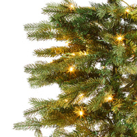 Close-up of the Celeste Pencil Pine Christmas Tree 180cm, showcasing its slim design with branches illuminated by 220 small glowing yellow lights.