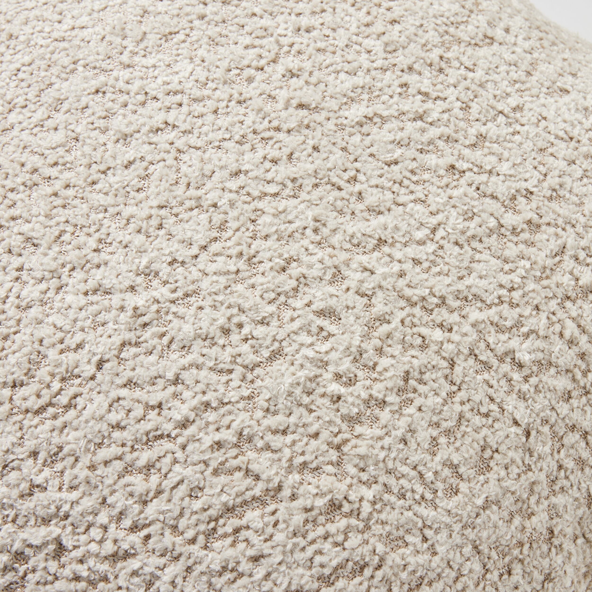 Close-up image featuring the textured fabric of the Byron Boucle Cushion in Oatmeal, highlighting its boucle pattern.