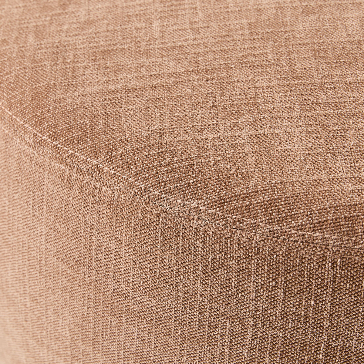Close-up of a polyester weave fabric covering the curved surface of a Tango Round Ottoman Large Solace Dusty Pink, showcasing its elegant texture.