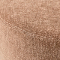 Close-up of a polyester weave fabric covering the curved surface of a Tango Round Ottoman Large Solace Dusty Pink, showcasing its elegant texture.