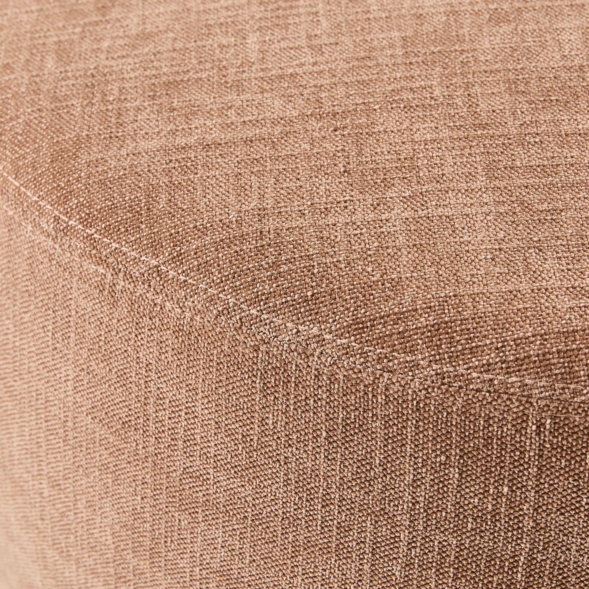 Close-up of a polyester weave fabric covering the curved surface of a Tango Round Ottoman Large Solace Dusty Pink, showcasing its elegant texture.