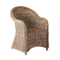 The Martinique Rattan Armchair boasts a rounded back and armrests, showcasing a natural woven pattern inspired by European design that captures tropical beauty.