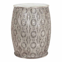 The Surat Metal Stool (34.5x34.5x41.5cm) is a polished antique silver drum-shaped stool adorned with circular floral patterns.