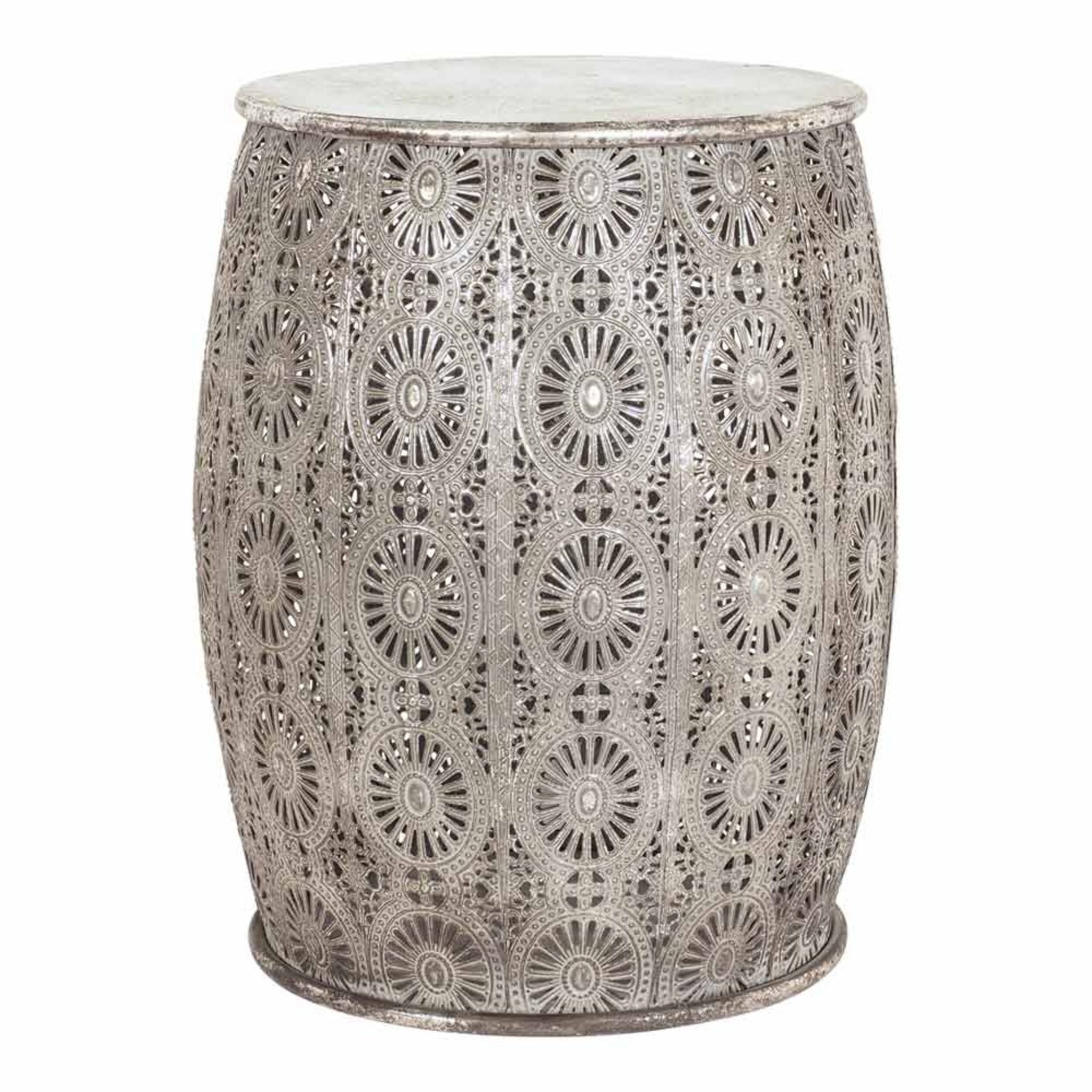 The Surat Metal Stool (34.5x34.5x41.5cm) is a polished antique silver drum-shaped stool adorned with circular floral patterns.