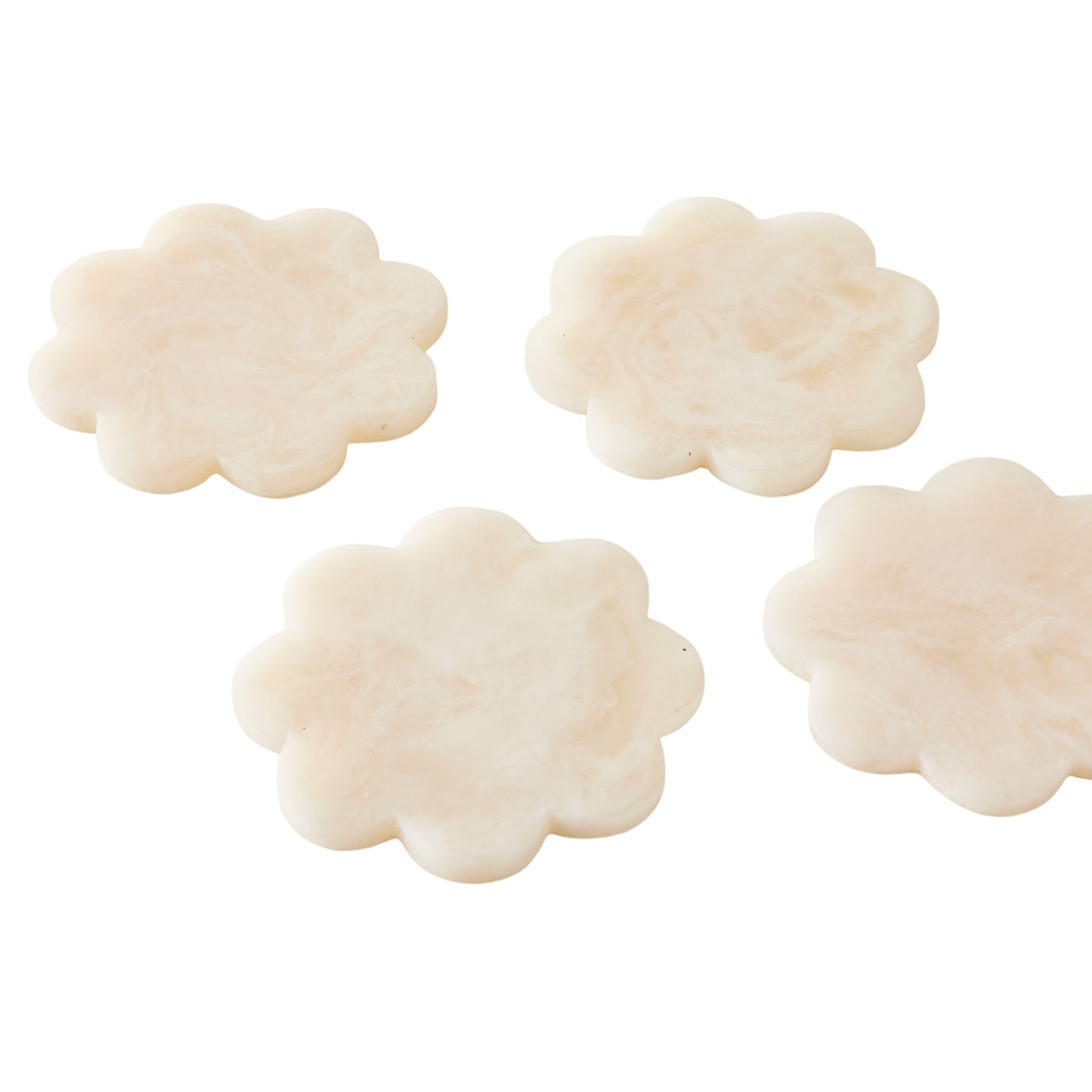 The Poppi Scallop Coasters Set of 4 Pearl features cream-colored, flower-shaped resin coasters with a marbled texture, shown arranged on a white background.