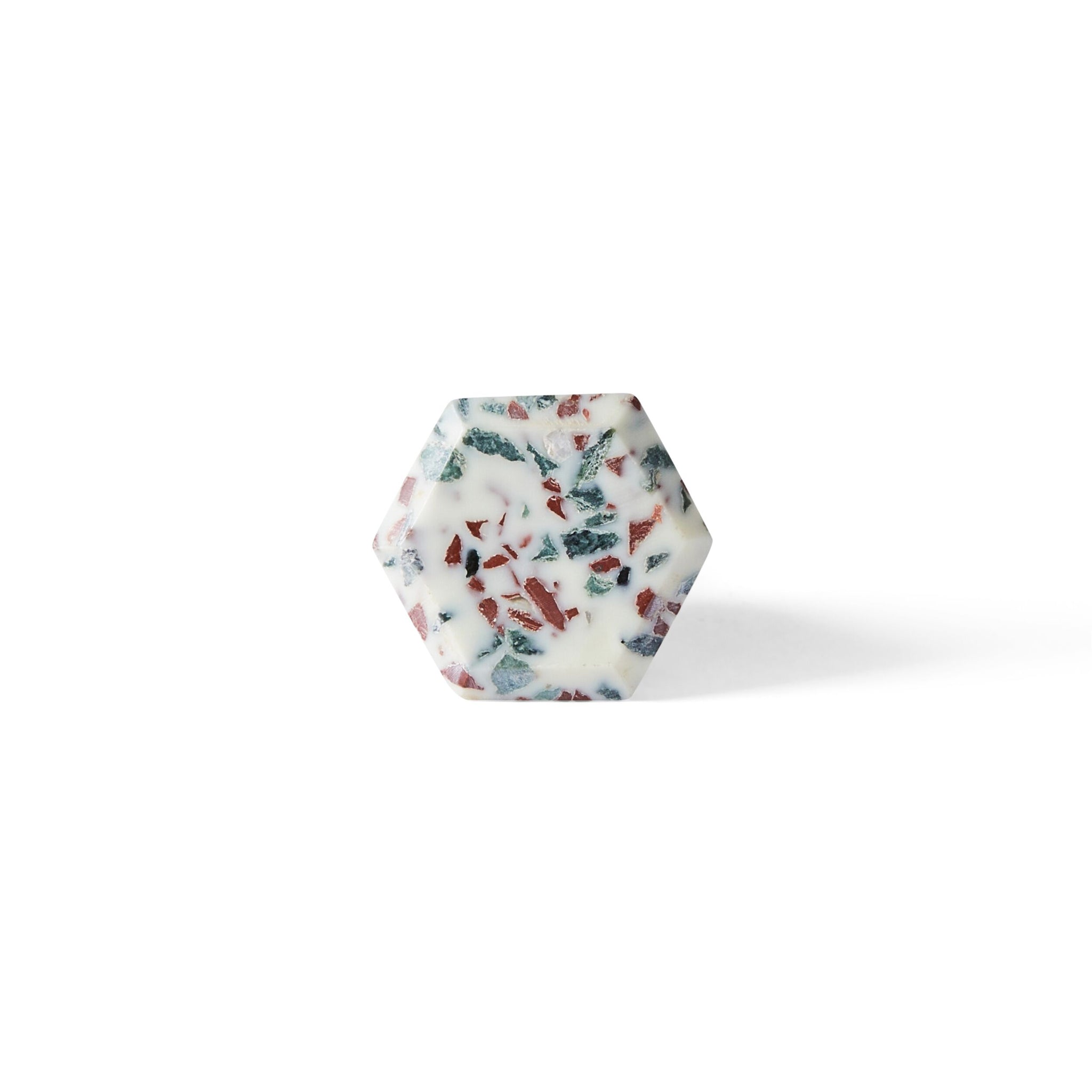 The Speckle Geo Knob 3.8cm features a hexagonal shape, white base, and embedded red and green specks—ideal as a decorative cabinet knob, shown here against a plain white background.