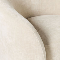 Close-up of the Alessa Swivel Armchair Oasis Dune, featuring beige chenille upholstery. Its textured fabric, curved armrest, and smooth surface add a stylish touch to any home decor.