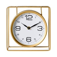 The Caged Mantel Clock Gold 18x18x7cm features a round gold face with black numbers, set at 10:10, and is enclosed in a minimalist gold wire stand for a modern look.