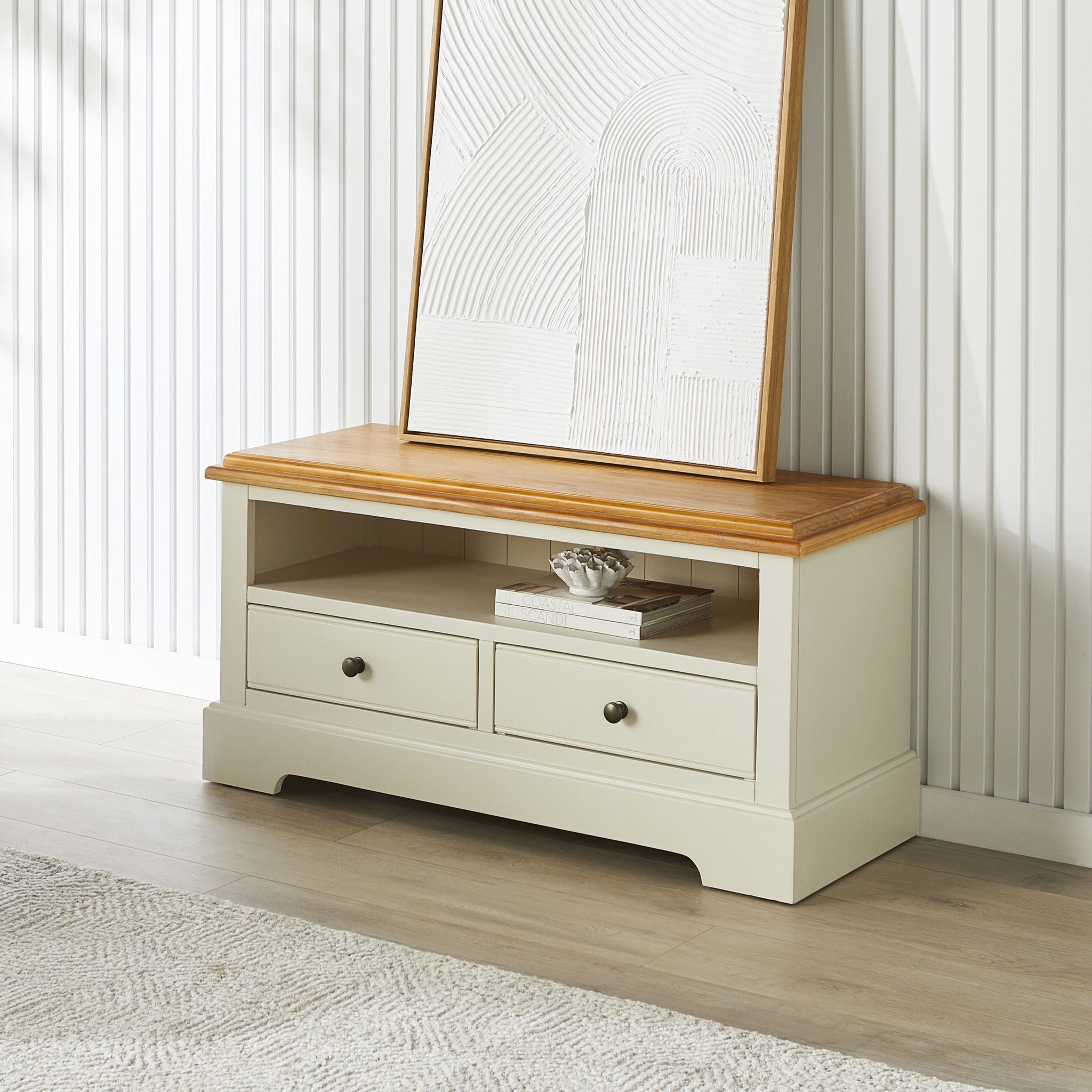 Full view of the white storage console with wooden top, two drawers, and an open shelf.