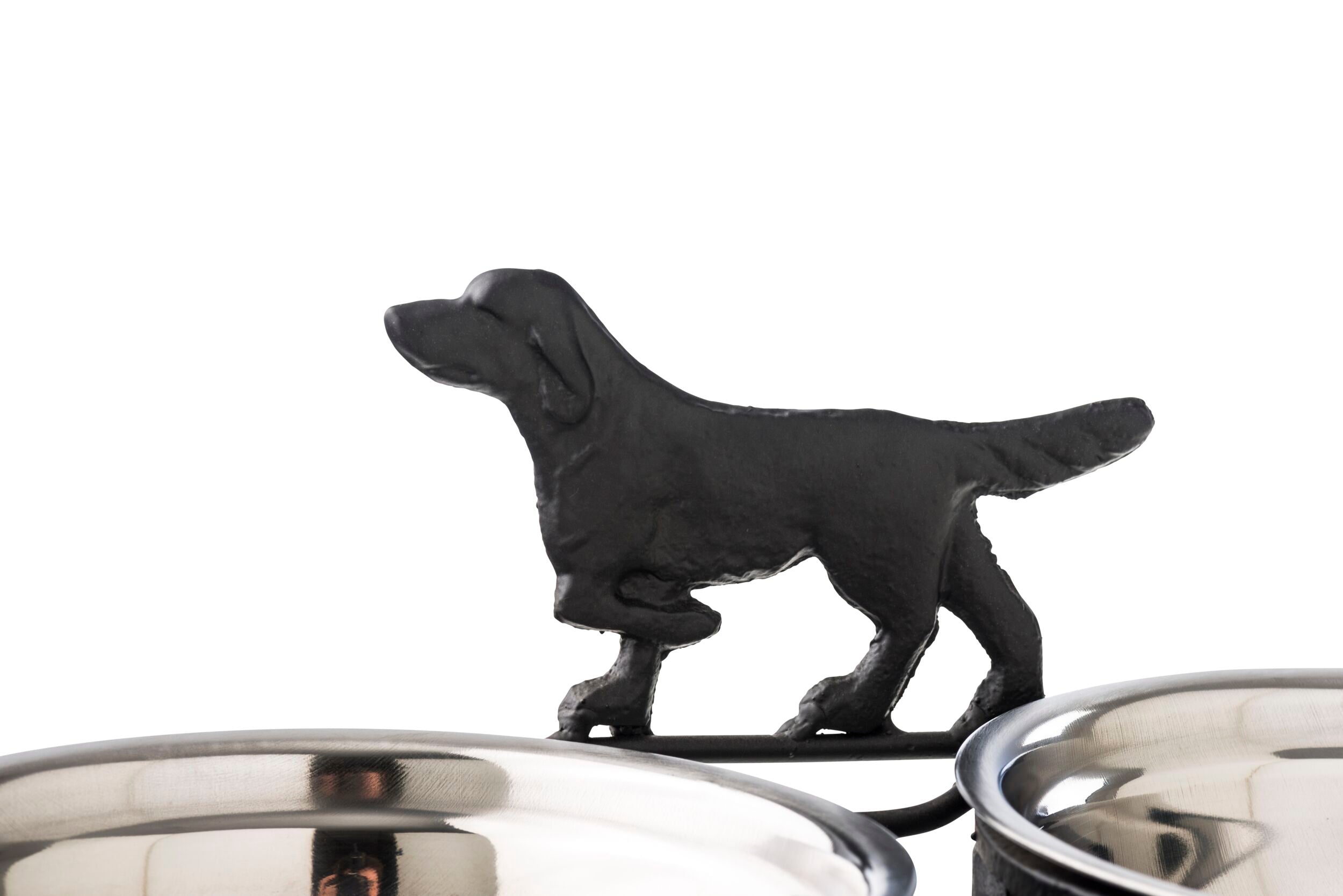 A silhouette of a dog serves as the decorative detail on the Double Dog Bowl 35x17cm, featuring a durable iron stand crafted in an elegant antique black and silver finish, complete with two stainless steel pet food bowls.