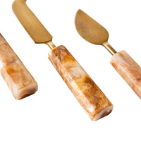 Poppi Cheese Knives Set of 3 Tortoiseshell, featuring a spreader and pointed knife with marble handles and brass blades, elegantly displayed against a white background.