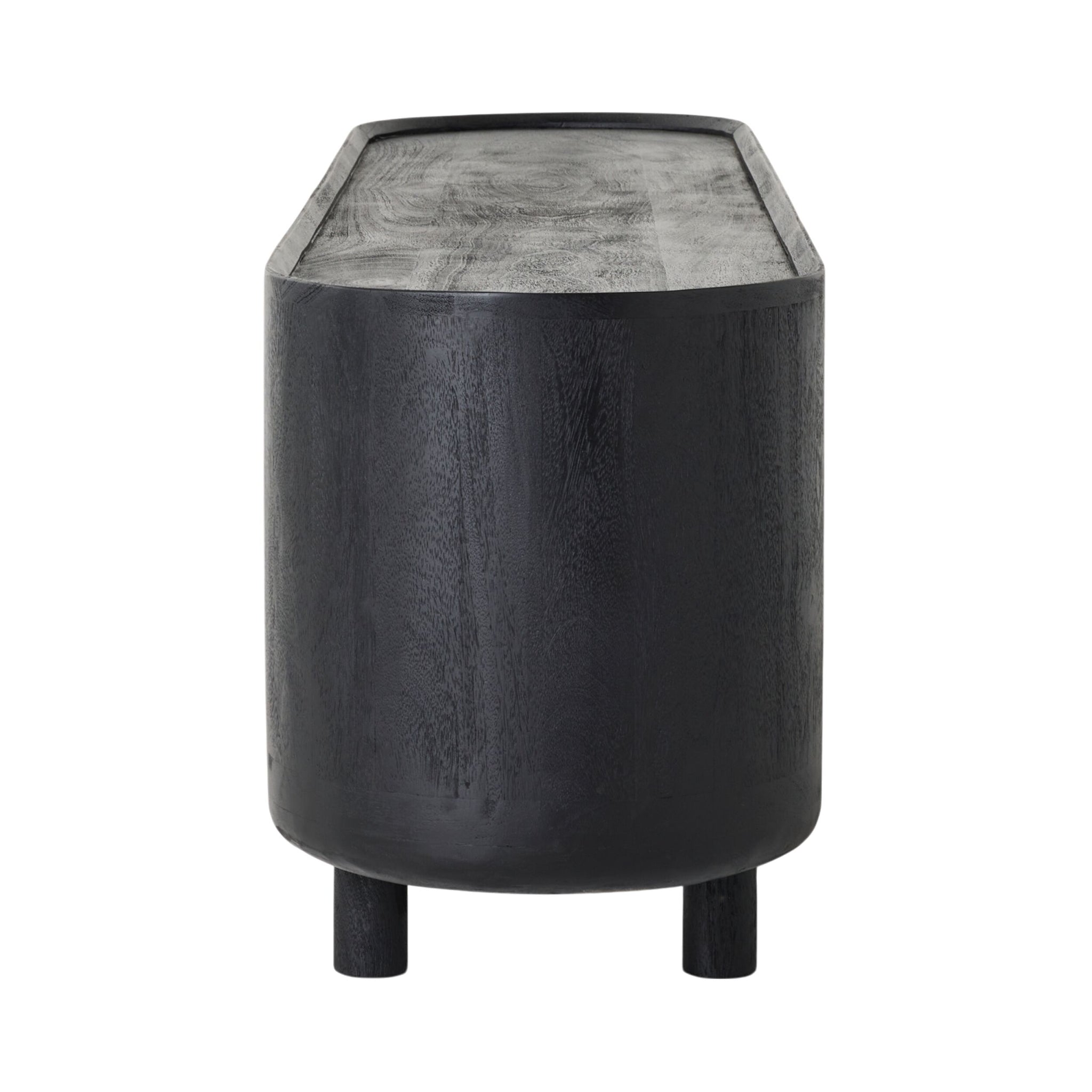 A cylindrical dark wood side table with a black sandblasted finish, two short legs, and a subtly textured flat surface complements the Aurora Entertainment Unit Black for cohesive media storage.