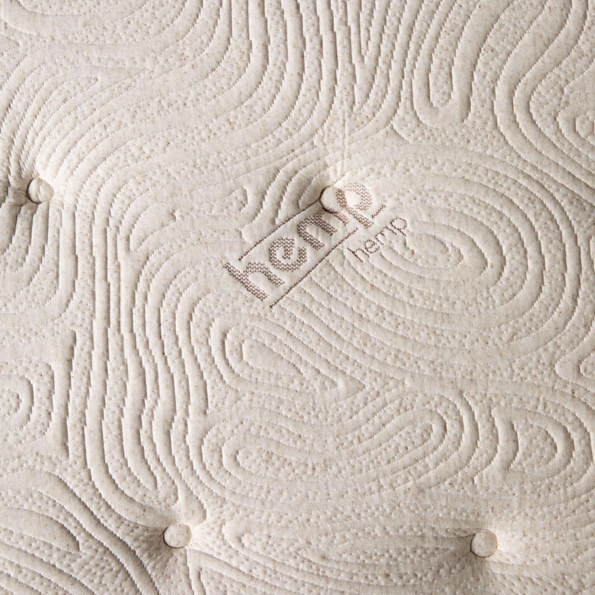A close-up reveals a textured mattress cover with stitched patterns and "hemp" beautifully embroidered. Beneath lies the Annie Premium Mattress Double, featuring a supportive 5-zone pocket spring system for ultimate comfort.