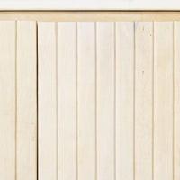 A close-up of a wooden panel with vertical grooves reveals a light, natural texture, reminiscent of the whitewashed mango wood finish of the Deva 2 Door Buffet 114 x 80 x 43cm, highlighting its refined elegance and subtle charm.