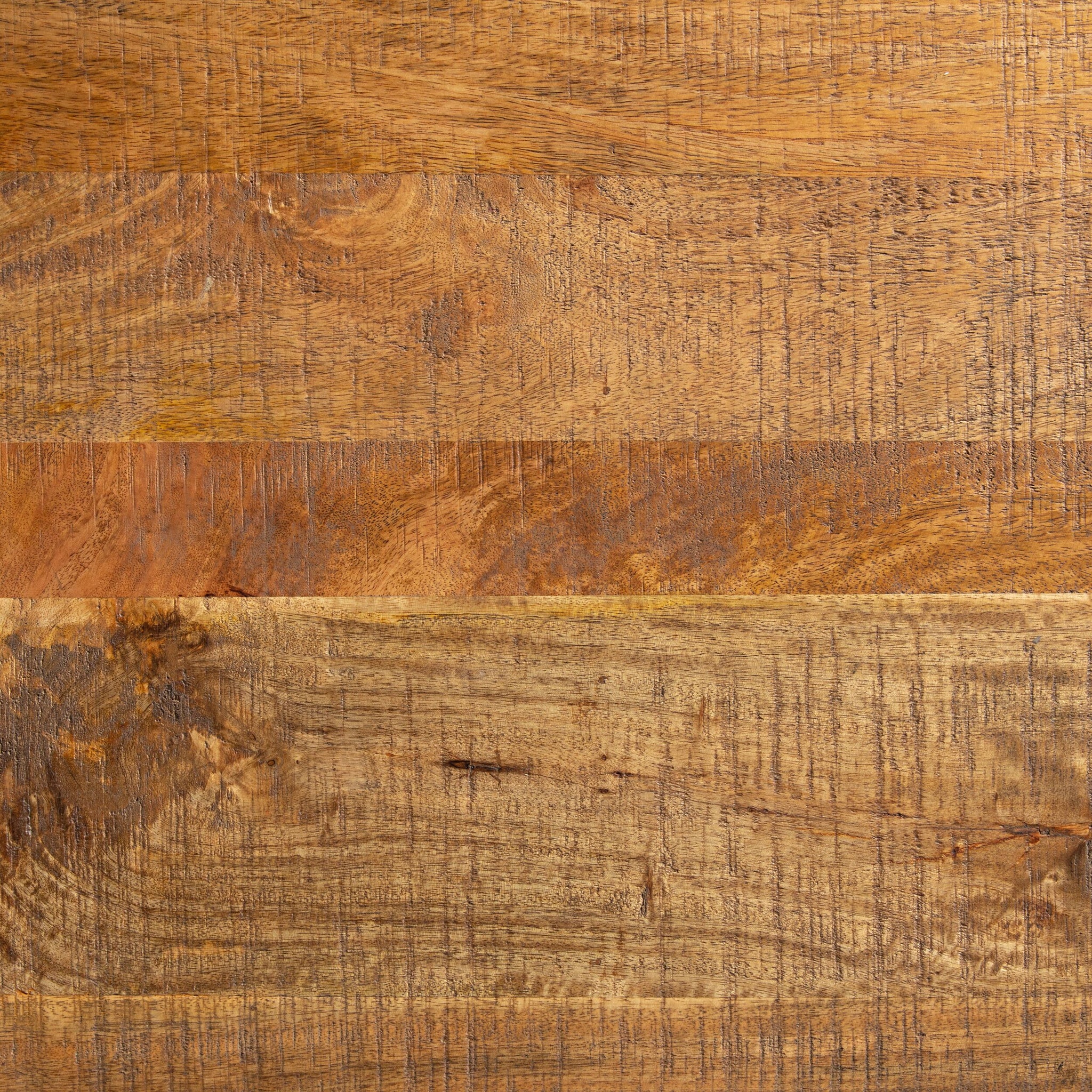 A close-up of the Fulham 2 Drawer Desk's mango wood surface highlights its natural grain, knots, and varied brown tones—ideal for lending a contemporary edge to any space.