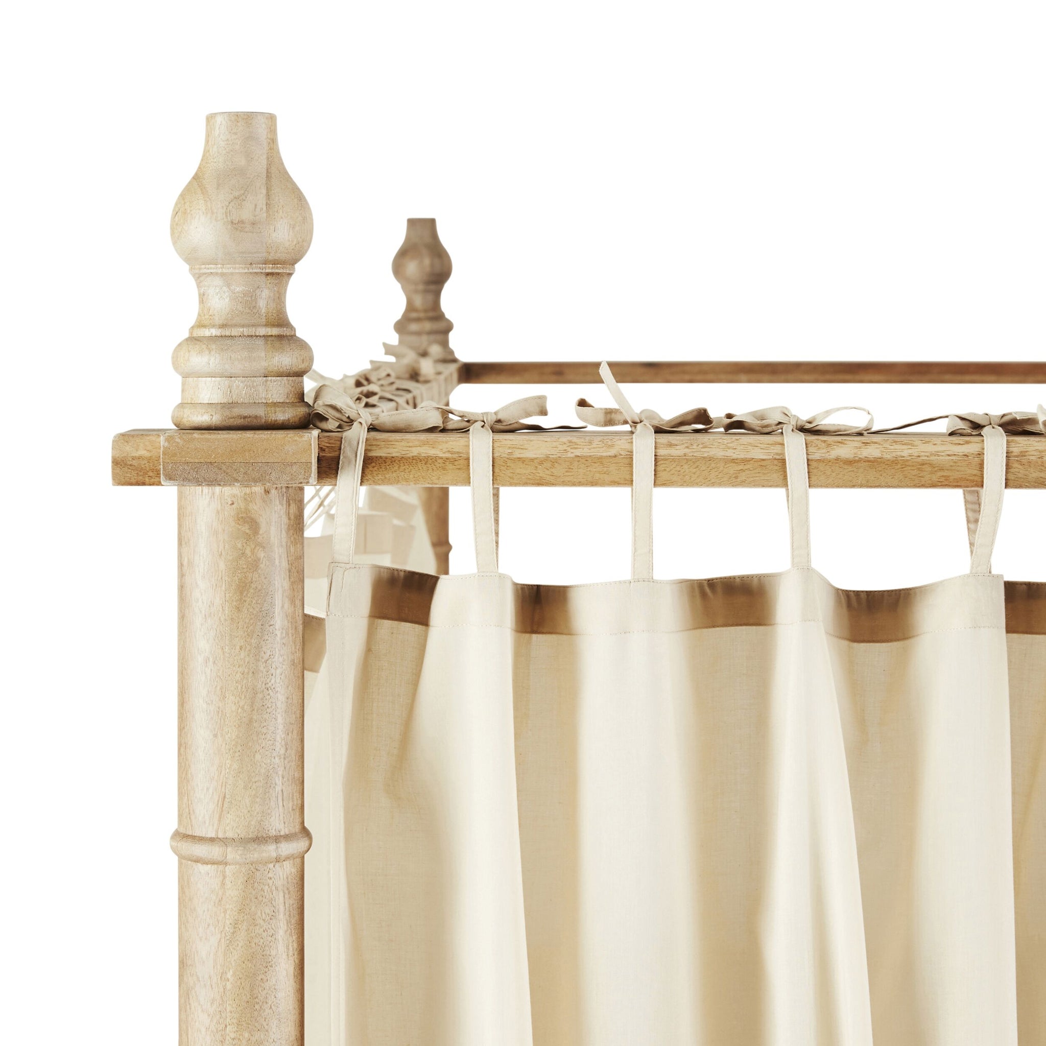 Close-up of a Hampton canopy bed highlighting the Hampton Cotton Voile Curtain - Set of 6 in beige, elegantly tied to the frame.