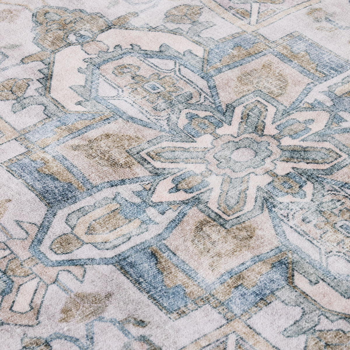Close-up of the Manisa Washable Rug 240x300cm, showcasing Persian-inspired geometric and floral motifs in muted blue, beige, and cream tones, crafted from durable polyester.