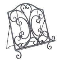 The Tissue/Book Stand 31x22x35cm boasts a decorative black metal design with an antique silver finish, featuring ornate scrollwork and an adjustable support chain for vintage elegance.