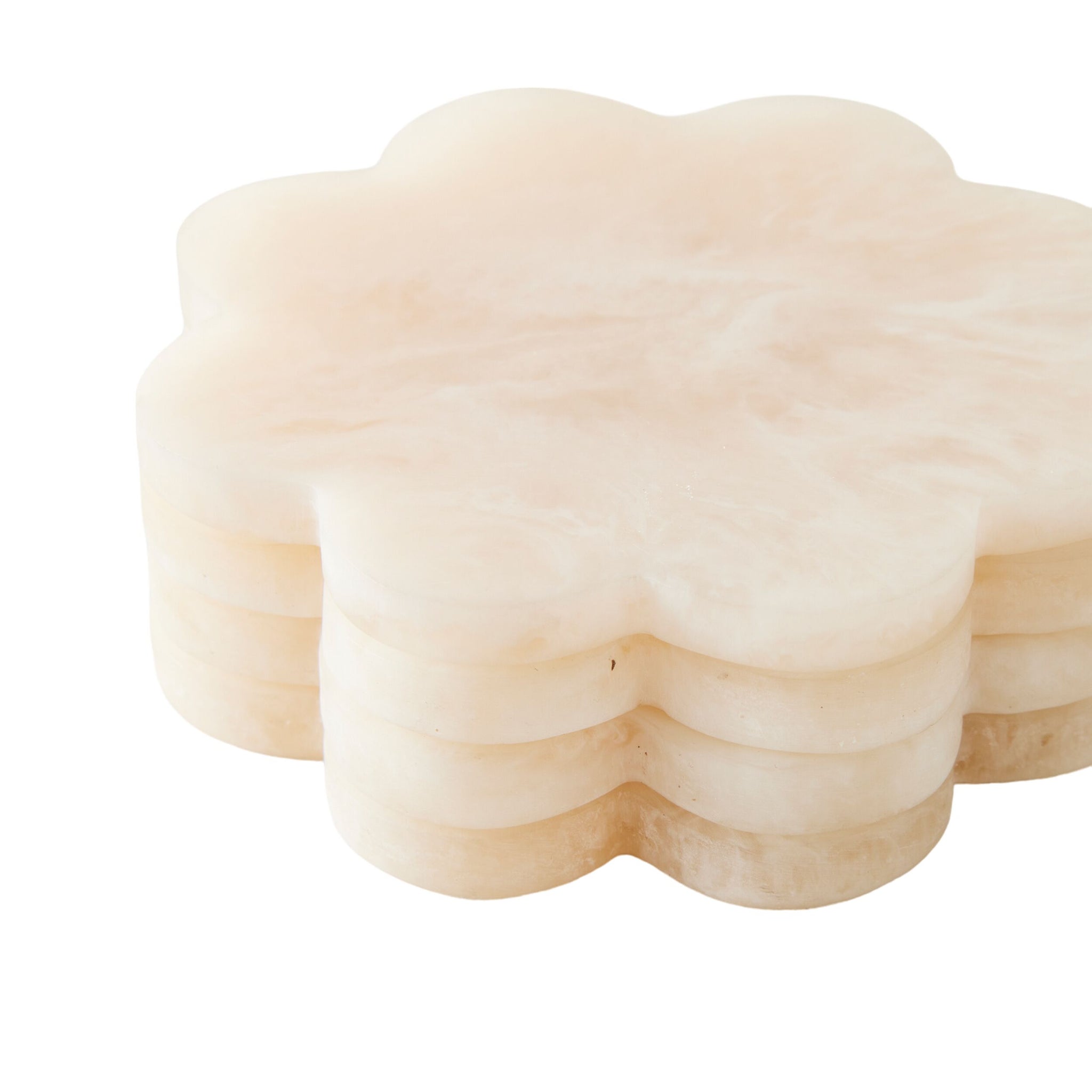 The Poppi Scallop Coasters Set of 4 in Pearl features cream-colored, flower-shaped coasters—perfect handmade pieces to add elegance and charm to any setting.