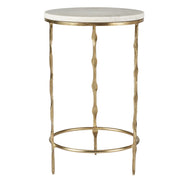A gold side table with a marble top
