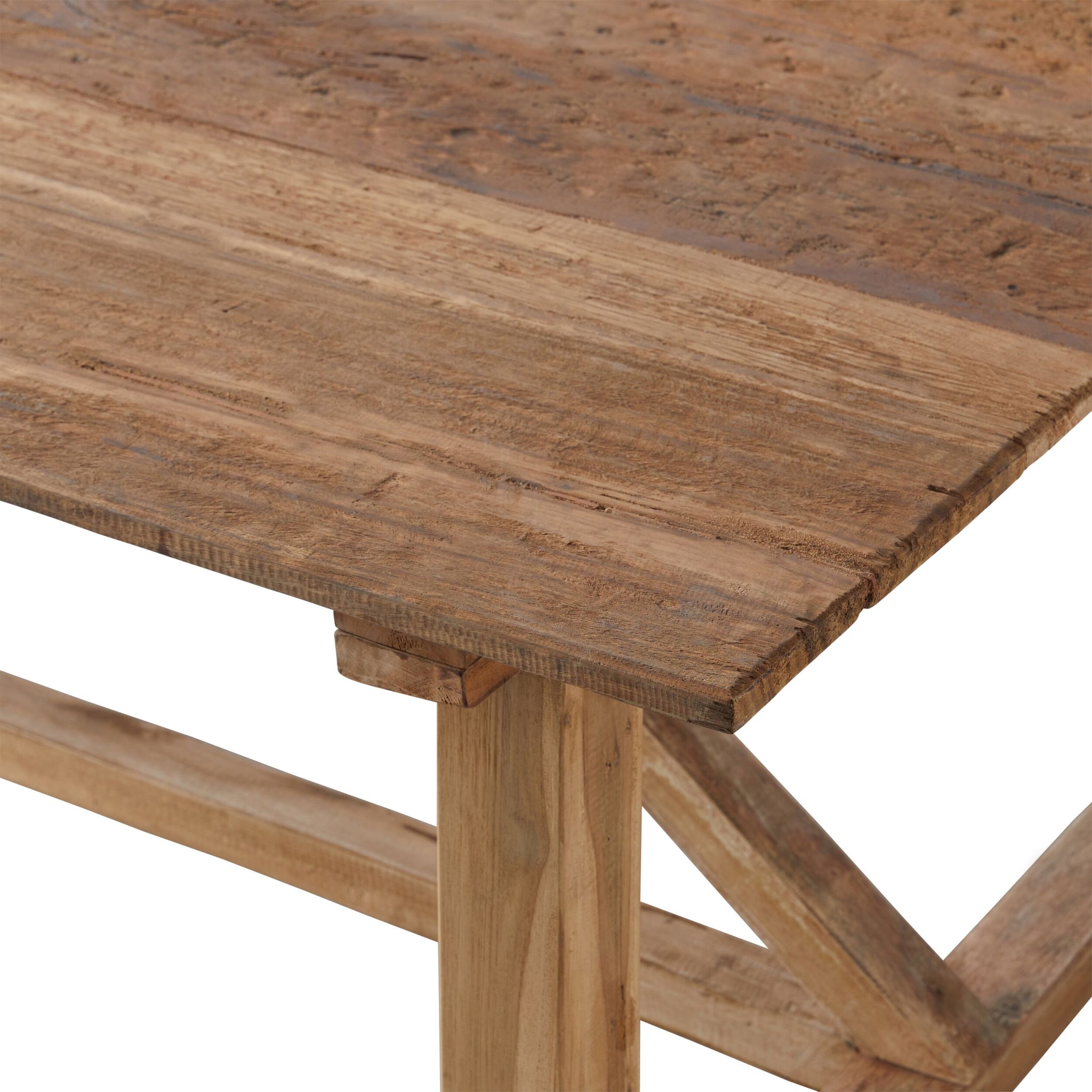Close-up of the corner of the Barndo Reclaimed Dining Table 240x100cm. Crafted from reclaimed timber, it showcases rustic texture and grain, with simple, sturdy legs that enhance its timeless appeal.