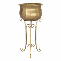 The Jiya Metal Plant Stand (38x38x80cm) features a gold, textured bowl atop a tall, ornate three-legged base with a polished iron finish, perfect for complementing indoor plants.